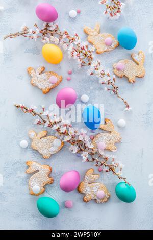 Homemade almond bunny cookies for Easter with colorful Easter eggs Stock Photo