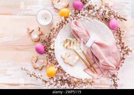 Easter table setting with colorful eggs and homemade bunny cookies Stock Photo