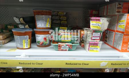 Supermarket Shelf with reduce to clear food products in Tesco supermarket, yellow label food Stock Photo