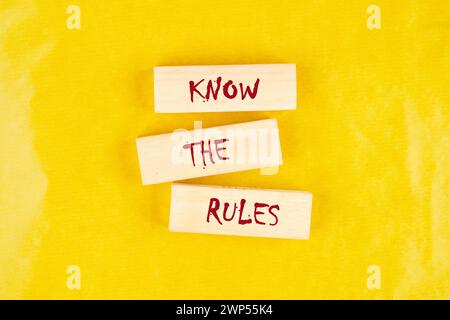 Know the Rules text on wooden blocks on a yellow background Stock Photo