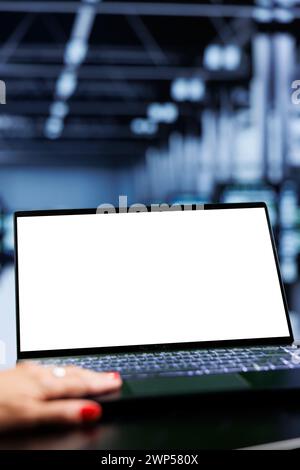 Close up shot of mock up laptop used by admin in server room delivering massive computing power, capable of processing and storing vast amounts of data and controlling network resources Stock Photo