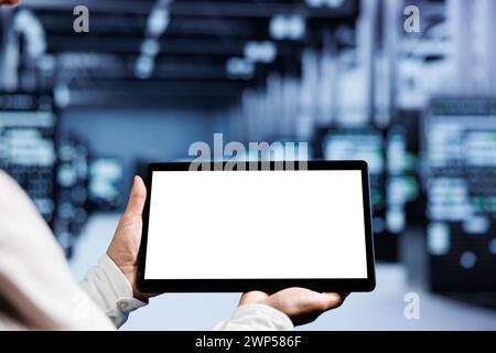 Close up shot of mock up tablet used by professional in server room delivering massive computing power, capable of processing and storing vast amounts of data and controlling network resources Stock Photo