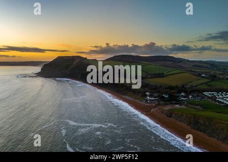 Seatown, Dorset, UK.  5th March 2024.  UK Weather.  Aerial view of the sunset at Seatown on the Dorset Jurassic Coast as the skies clear after a morning of rain.  Picture Credit: Graham Hunt/Alamy Live News Stock Photo