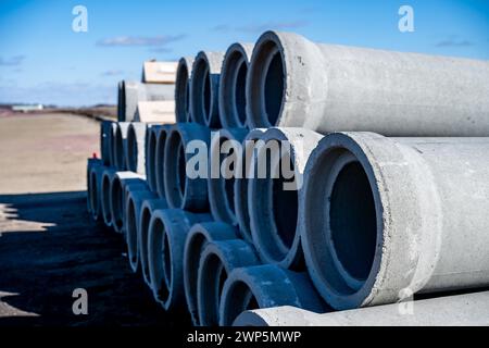 Stacked concrete casing pipes for sewer and water in the sky Stock Photo
