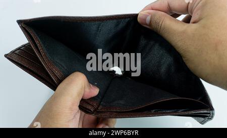 Empty wallet opened by hand isolated on white background Stock Photo