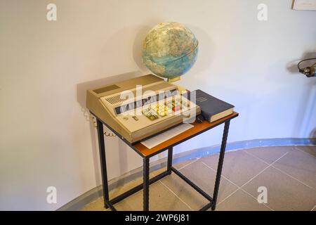 A globe and some sort of old, scientific office machine on display in a room at the base of one of the observatory buildings. At the astronomical obse Stock Photo