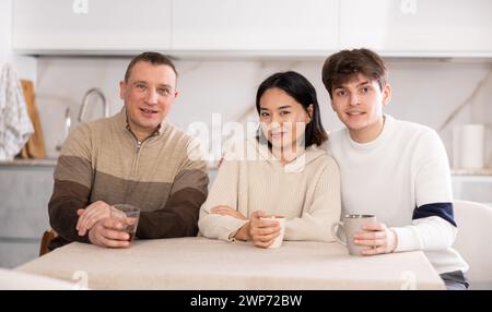 Portrait of happy family - married couple and father at home Stock Photo