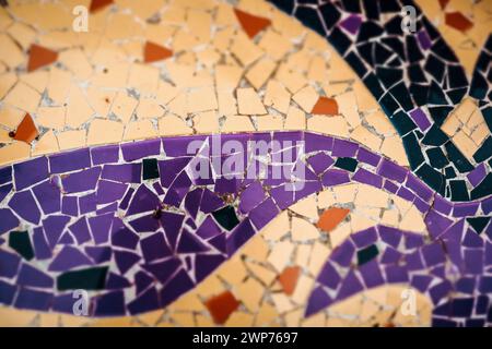 Multicolored violet, orange, yellow ceramic mosaic details. Colorful artwork abstract background. Architecture decoration. Mosaics wall surface. Stock Photo