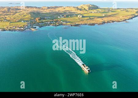 Calmac ferry leaving the Isle of Iona and crossing the Sound of Iona bound for Fionnphort on the Isle of Mull Stock Photo