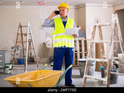 Construction worker having telephone conversation Stock Photo