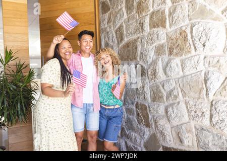 Diverse friends celebrate with American flags, with copy space Stock Photo