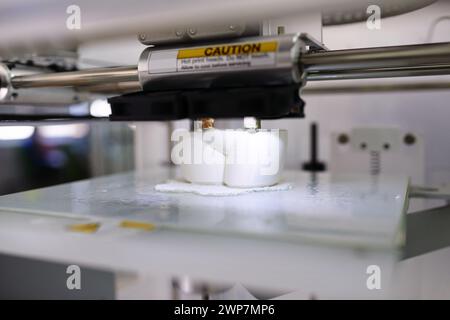 Closeup, 3d printer and prototype in lab for tech, creative and design in digital robot innovation. Printing, machine and model to process, robotic Stock Photo