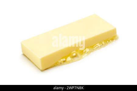 A piece of melting butter isolated on white background Stock Photo