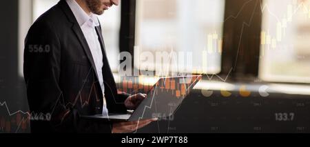 Side view of a focused businessman analyzing complex financial data on his laptop Stock Photo