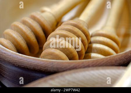 Group of handmade wooden honey dippers, close-up shot, abstract kitchenware background Stock Photo