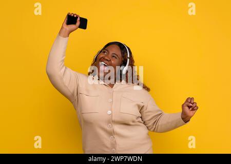 Positive african american overweight woman have disco Stock Photo