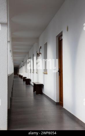 A long, straight corridor with white walls Stock Photo