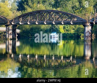 A very scenic part of the River Thames as it joins Hinksey Stream at Kennington. . The scene is dominated by an abandoned railway bridge, unused for m Stock Photo