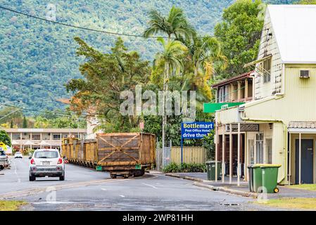 Two sugarcane train locomotives named Douglas and Faughy pulling sugarcane mill bins through the town of Mossman in Queensland, Australia Stock Photo