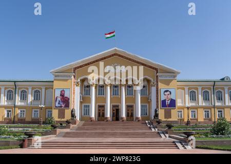 View of Arbob Palace facade with portraits of national hero Ismoil Somoni, president Emomali Rahmon and Tajik flag, Khujand, Tajikistan Stock Photo