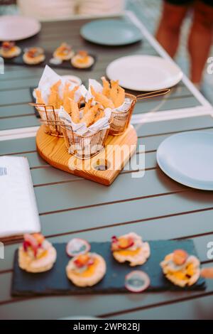 Delicious fried shrimps elegantly served with sauces on the restaurant table, Portugal Stock Photo