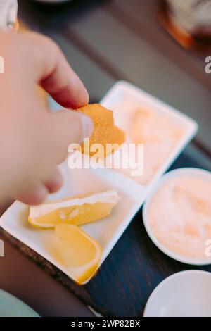 Delicious fried shrimps elegantly served with sauces on the restaurant table, Portugal Stock Photo