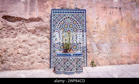 The exterior wall adorned with decorative tiles in a stunning design Stock Photo