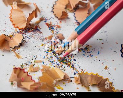 A close-up of assorted colorful pencils arranged on a white table surface Stock Photo