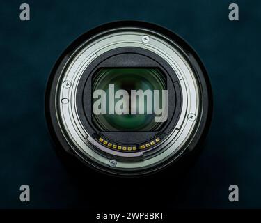 A Canon RF 24-70 F2.8 IS USM mirrorless full frame lens on a dark background Stock Photo