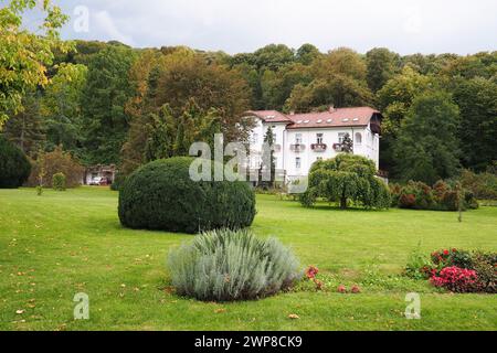 Banja Koviljaca, Serbia, Guchevo, Loznica, September 30, 2022 A medical building, the former royal villa. Green lawn in the park with flowers and bush Stock Photo