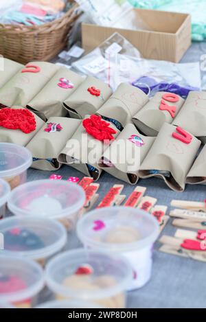 Crafts for sale showcased with plastic containers and clothespins Stock Photo