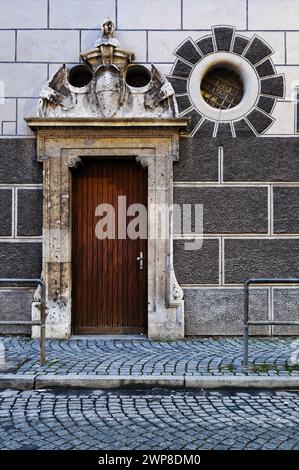 An Ornate entrance and round window of a building in Ulm an der Donau in Southern Germany Stock Photo