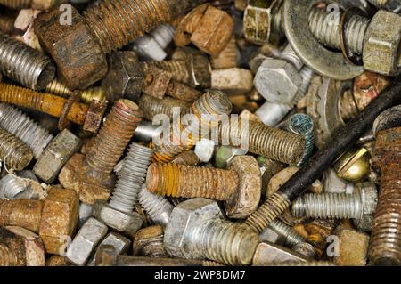 Assorted screws and nuts stacked together in a close-up view Stock Photo