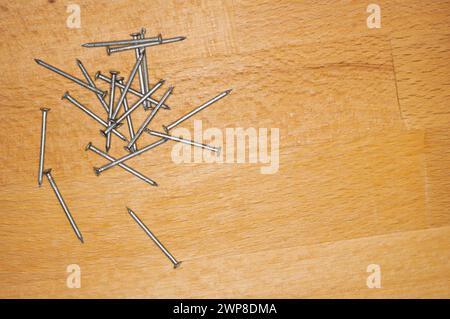 Some nails on a wooden board Stock Photo