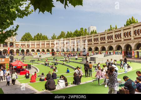 People sitting at the inner square of the Minyuan Stadium of Tianjin, China Stock Photo