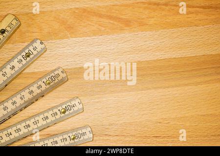 A Yardstick like a fan on a wooden board Stock Photo