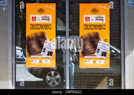 An unusual selfie of a photographer snapping 2 Yiddish posters announcing a mega shtreimel sale. In Williamsburg, Brooklyn in 2024. Stock Photo