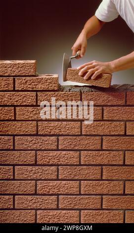 Bricklayer building Wall. Stock Photo