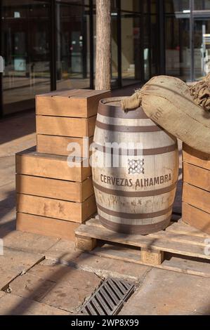Barcelona, Spain - March 06, 2024: Jute sacks and a wooden barrel on a pallet, evoking a rustic, traditional scene, ideal for craft brewery themes or Stock Photo