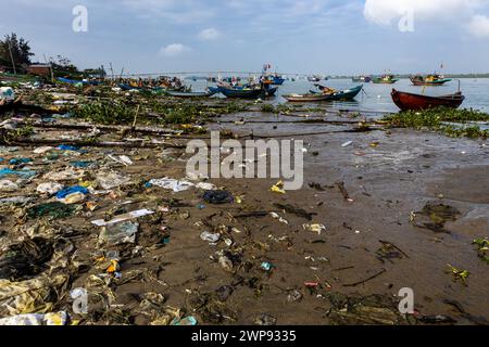 The dirty beach of the fishing harbor of Hoi An in Vietnam Stock Photo