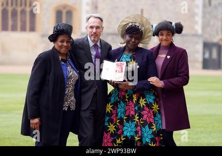Dame Margaret Aderin-Pocock (2nd right) poses for a photograph with her daughter Lori (right), husband Dr Martin Pocock (2nd left) and mother Carol Phillips (left) after being made a Dame Commander of the British Empire during an investiture ceremony at Windsor Castle, Berkshire Picture date: Wednesday March 6, 2024. Stock Photo