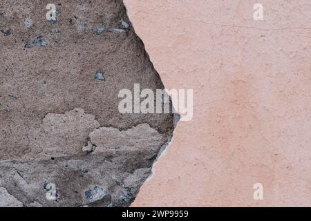 Fallen plaster from wall. Poor quality repairs. Crumbling facade building Stock Photo