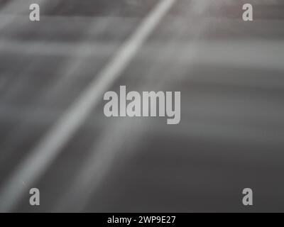 Illumination rays on gray surface. Abstract rays of light and lens flare on a gray background. Vertical, horizontal and diagonal light stripes Stock Photo