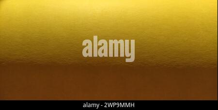 The paper or fabric material is bright yellow. Close-up. Slightly folded sheet. Light gradient and accentuated rough surface texture. Background or Stock Photo