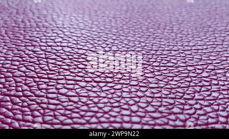 Artificial leather is bright pink or fuchsia. Distinct furrows and elevations on the surface of a bag or shoe. Reflection of the light. Fashion Stock Photo