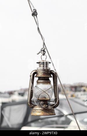 Kerosene lantern hanging from a wire on a sailboat Stock Photo