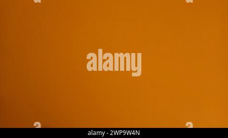 Abstract background of dark yellow, orange and ocher colors. Gradient from light to dark. Amber hue. Textural background. Stock Photo