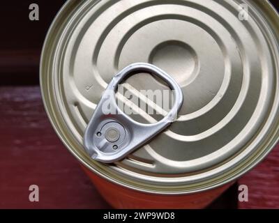 canned food lid with a bottle opener. Hook metal can top for easy opening Stock Photo