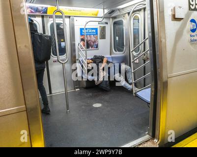 Man sleeping on NYC subway train Stock Photo - Alamy