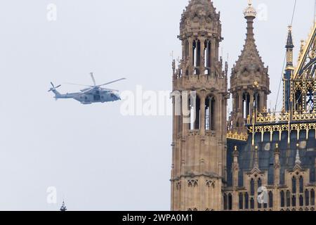 Houses of Parliament, London, UK. 6th Mar 2024. Large helicopter circles around Westminster. Credit: Matthew Chattle/Alamy Live News Stock Photo